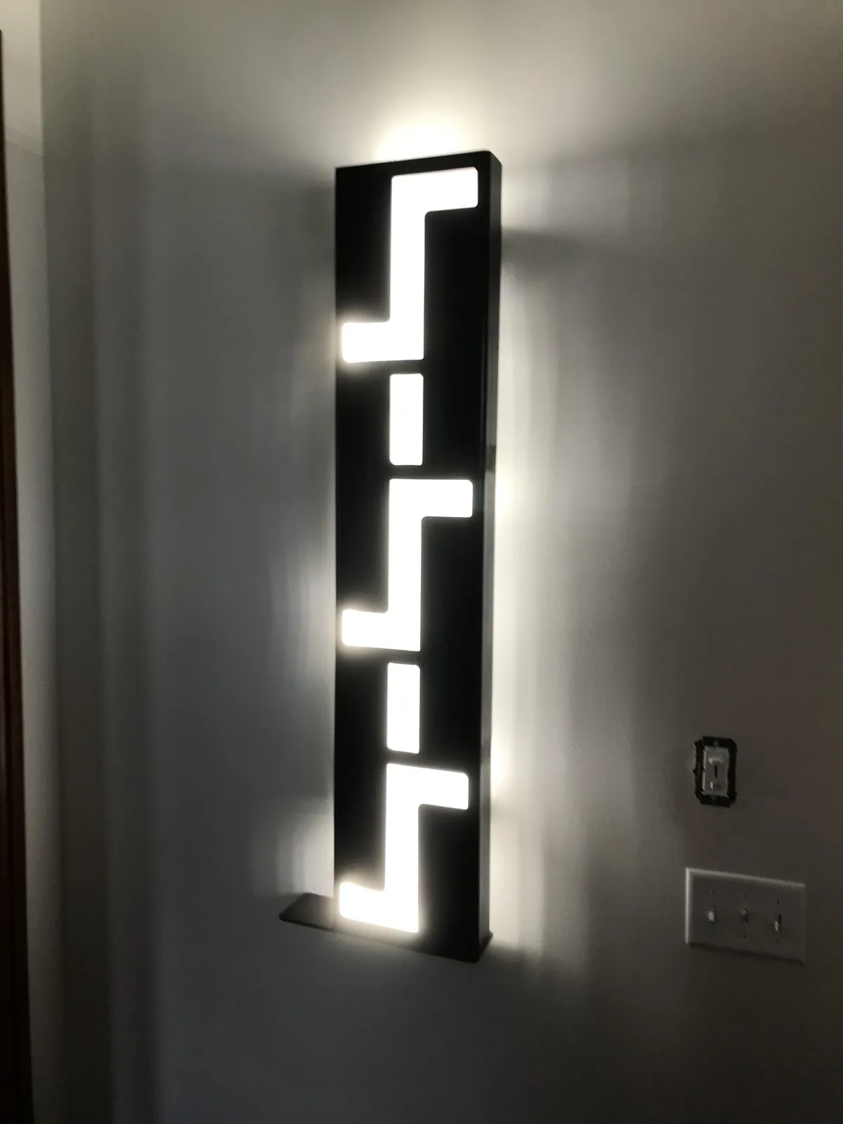 steel cutout light in the entryway of a historic house
