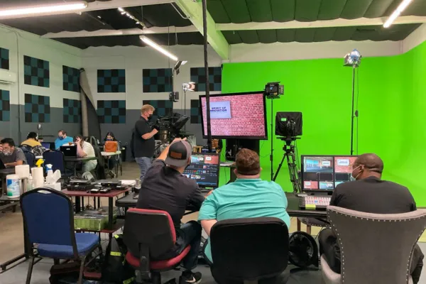 Production crew managing lighting and cameras during a live show at JDS Creative Academy.