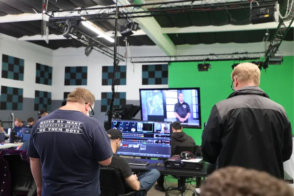 Neurodivergent creators working on digital media projects, collaborating, and learning skills at JDS Creative Academy in an inclusive, supportive environment.