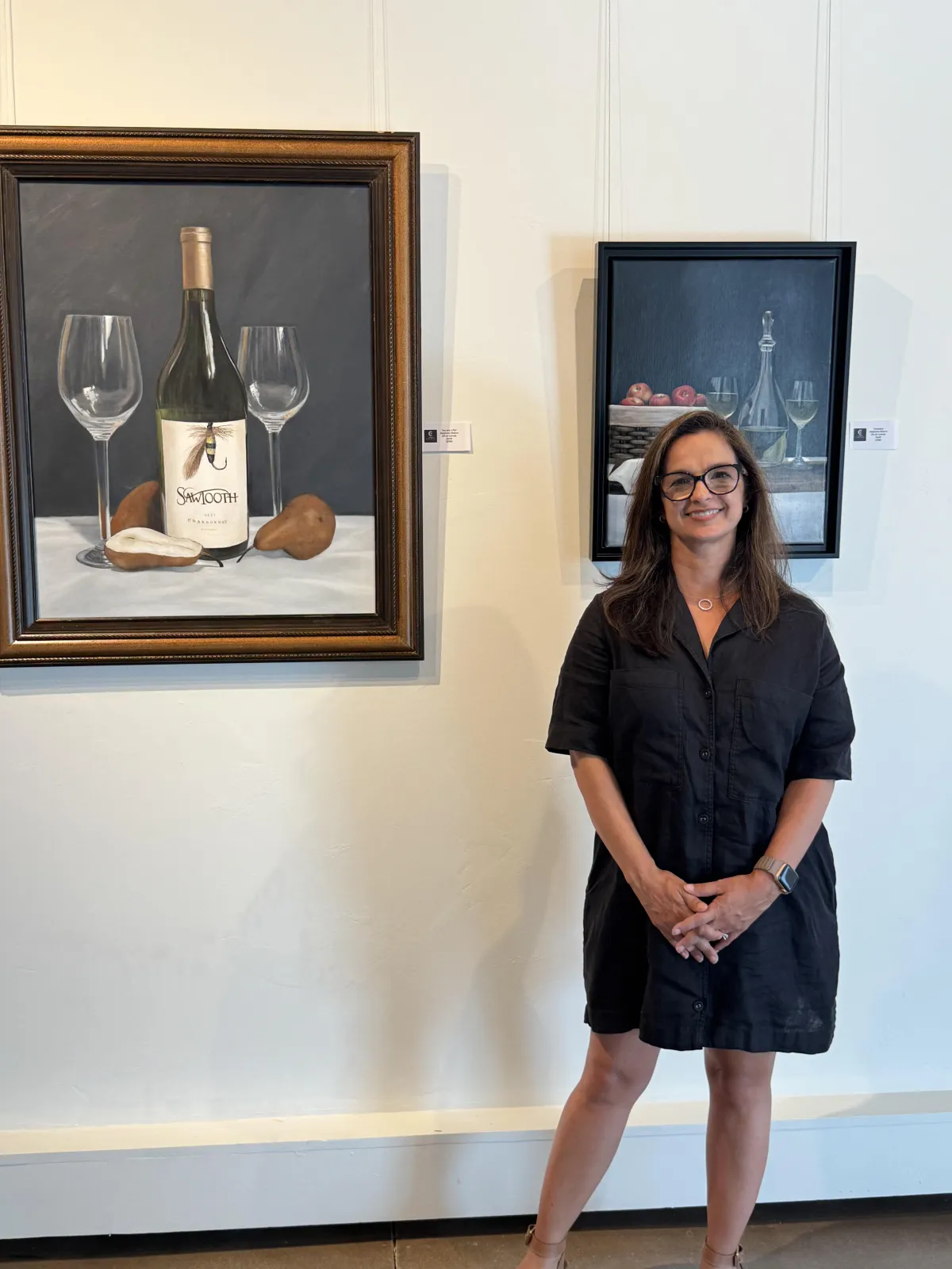 artist alejandra blanco in front of her artwork two are a pair and company available for purchase online or in person at create gallery and frames a fine art gallery and custom frame shop in garden city idaho