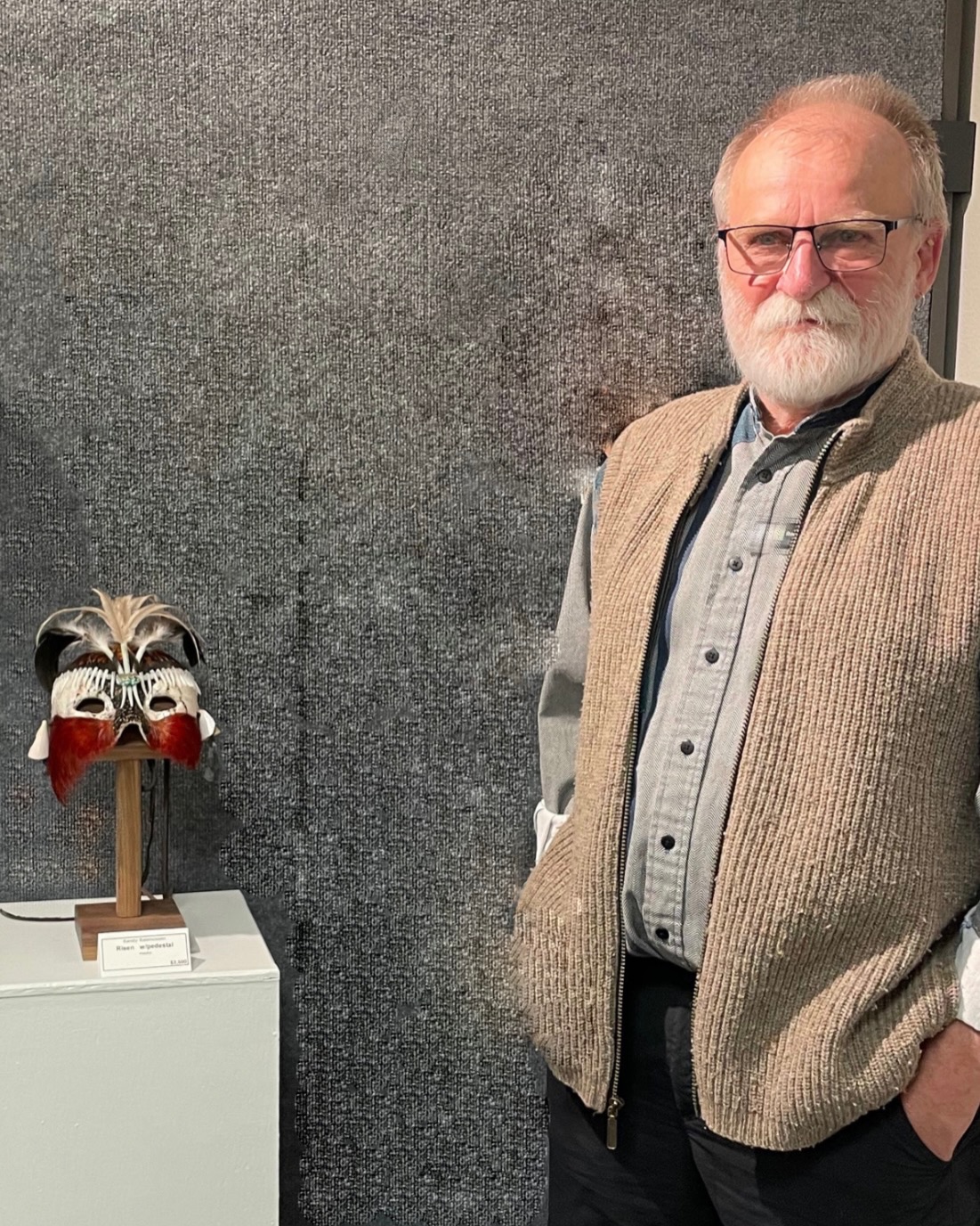 Randy Rasmussen standing beside his mixed-media Spirit Mask “Risen” at Create Gallery and Frames in Garden City, Idaho