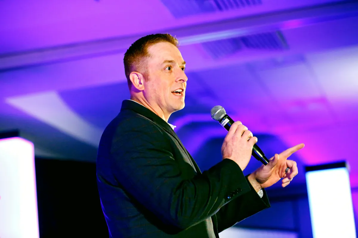 Chas Wilson speaking on stage