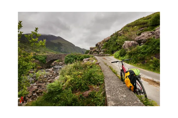 A bicycle leaning against a wall on a quiet country road, symbolizing simplicity and the joy of a balanced life.