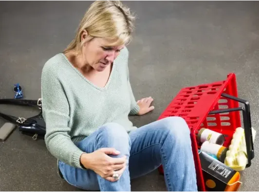Accident victim sitting on the floor after fall