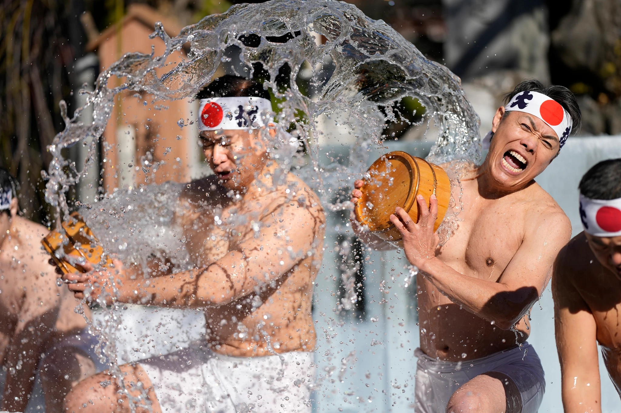 Shinto worshippers in white robes and loincloths step into freezing water at a Tokyo shrine as part of an annual purification ritual in January.