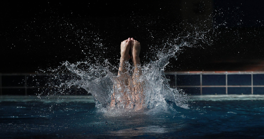 A professional diver named Ana performing three high-precision dives in slow motion, showing control, balance, and clean water entry.