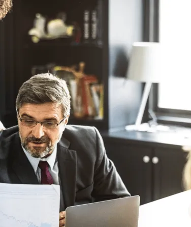 Business lawyer reviewing a legal document in an office setting.