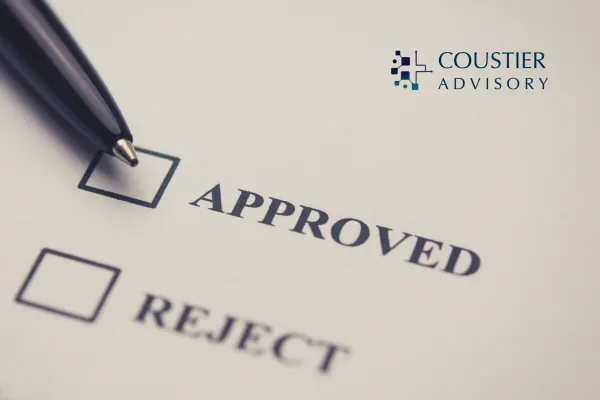 Close-up of a pen hovering over two checkbox options labeled "APPROVED" and "REJECT" on a form, symbolizing decision-making in CPT code applications.