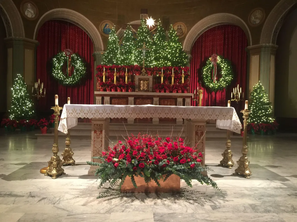 Charming church aisle Christmas garland weaving through pews, blending red berries, greenery, and golden festive ribbons.
