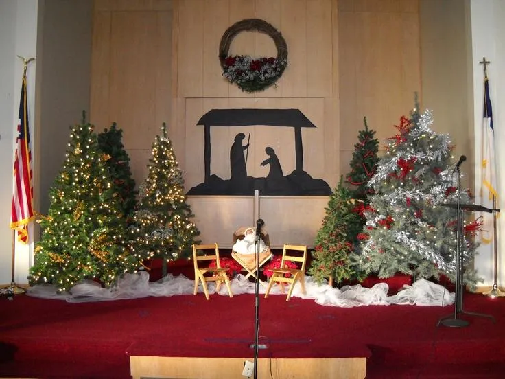 Altar floral Christmas decor with red poinsettias, greenery, and gold ribbons enhancing church holiday charm today.