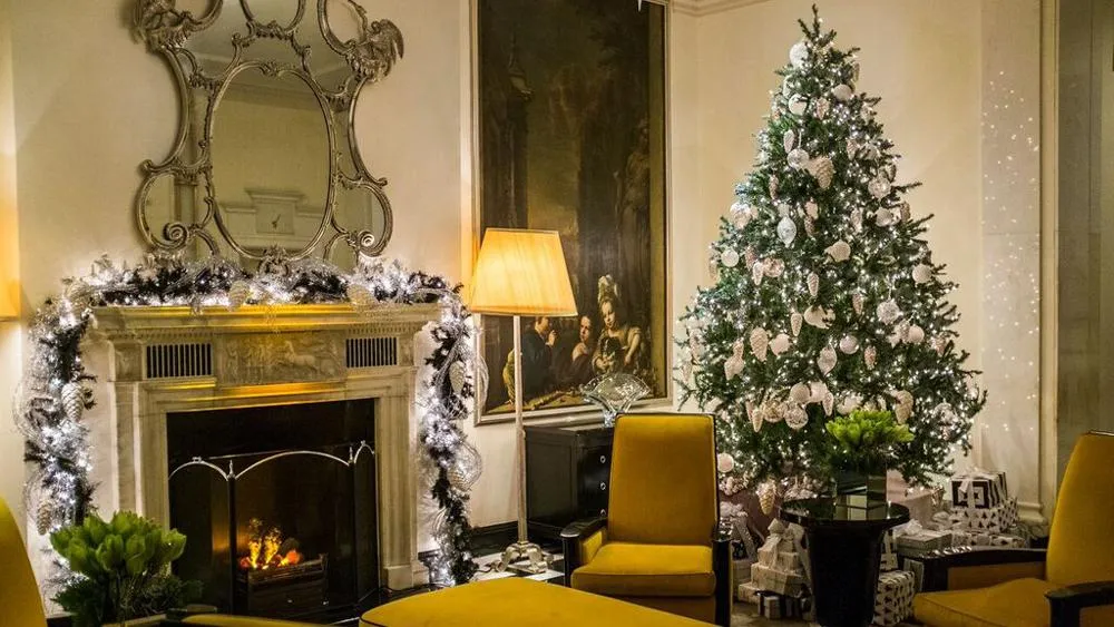 Hotel winter decor setup featuring frosted garlands, crystal lights, silver tones, and cozy festive elegance everywhere.