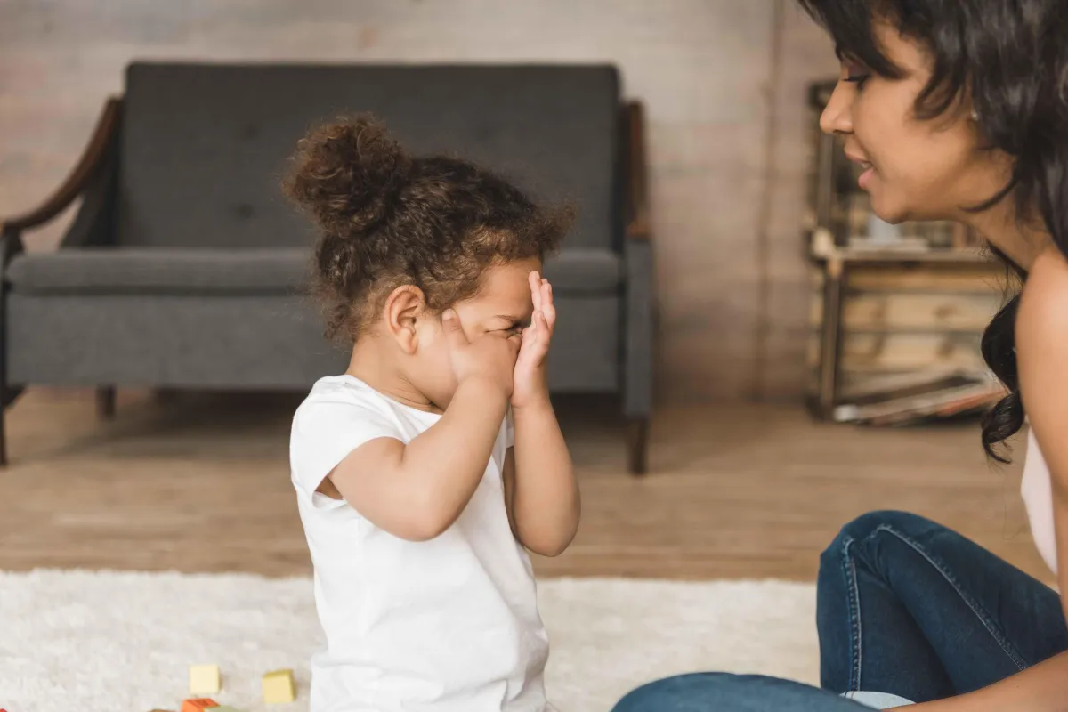 A mother is calmly navigating her toddler's tantrums.