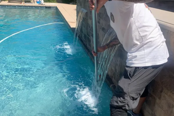 pool technician cleaning pool