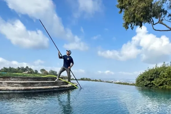 cleaning pool guy with pole