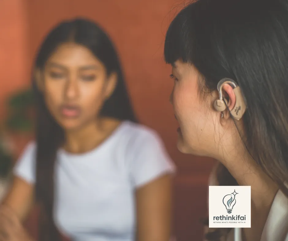 Woman wearing hearing aid talking with a colleague – accessibility and inclusivity concept with Rethinkifai branding.