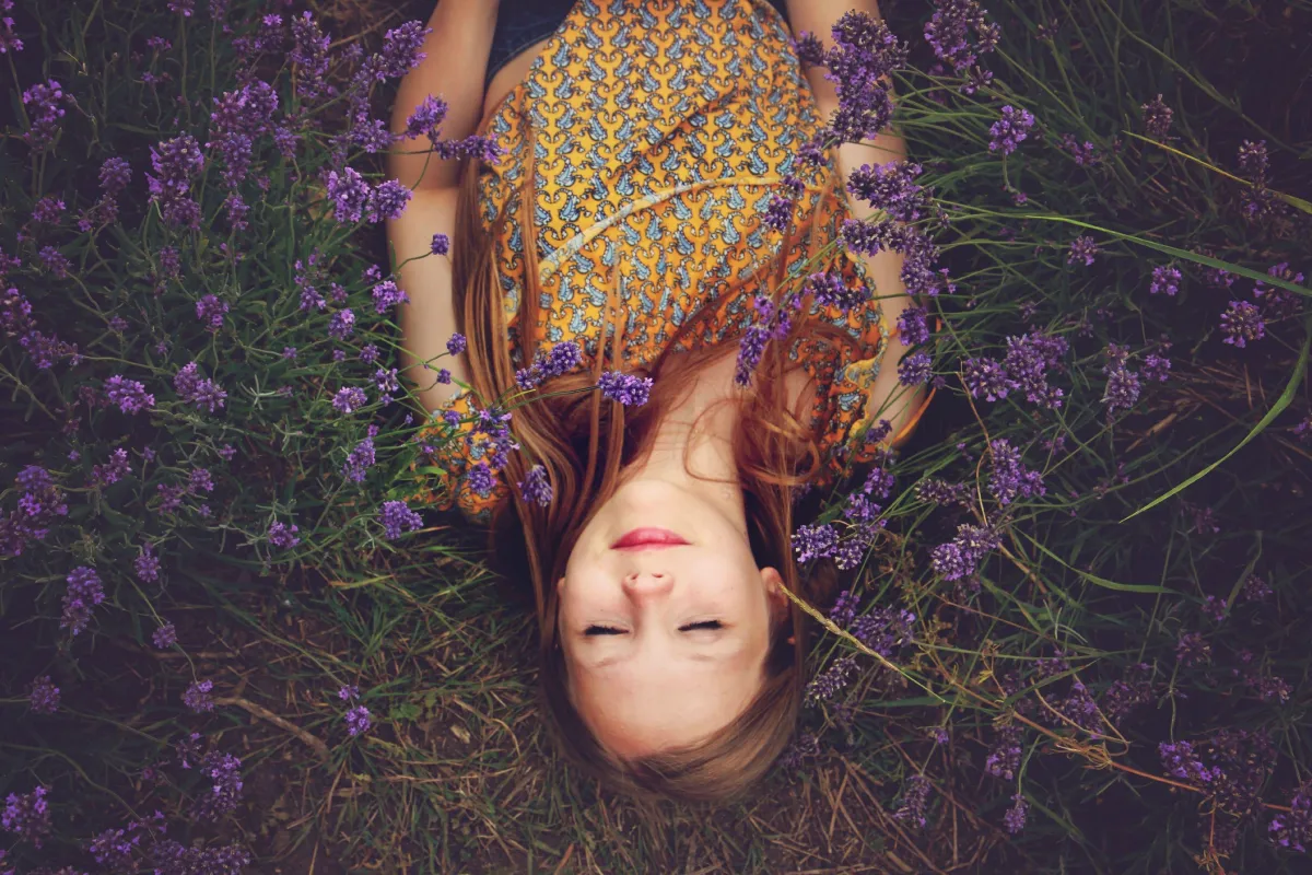 woman relaxing in a filed of purple flowers