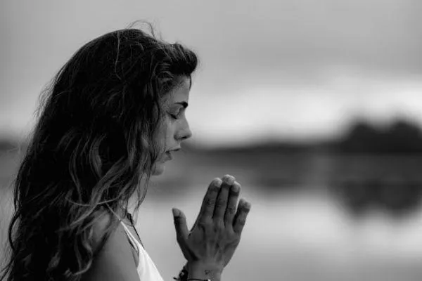 Black and white photo of a woman meditating 