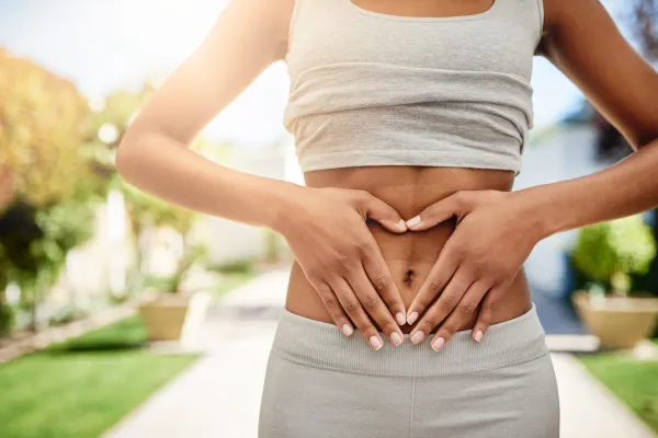 Woman with hands on her stomach