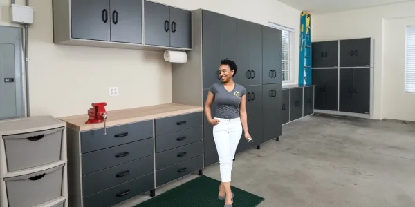 A professional organizer standing in a kitchen organizing cans on a lazy susan