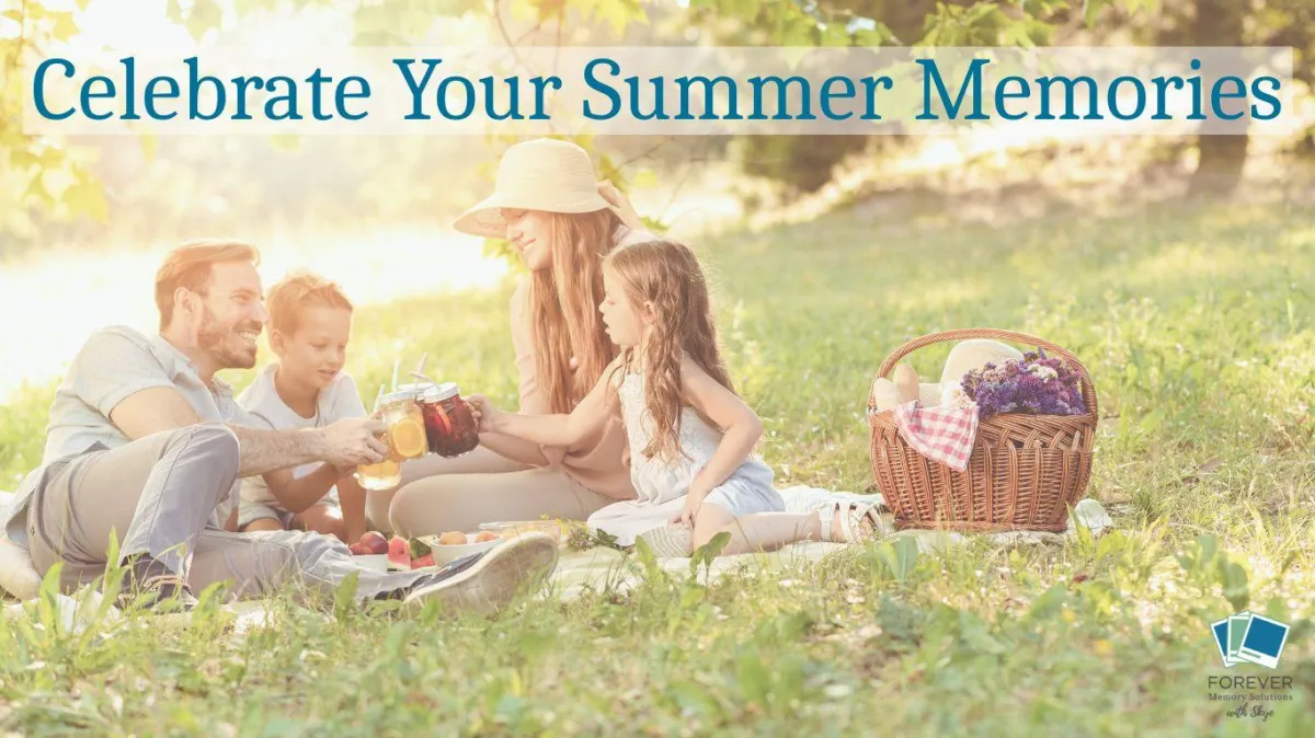 A smiling family of four enjoys a sunny summer picnic on the grass, raising mason jar drinks in a toast. A wicker basket with flowers and bread sits nearby. Overlaid text reads âCelebrate Your Summer Memories.â The FOREVER Memory Solutions with Skye logo appears in the bottom right corner.