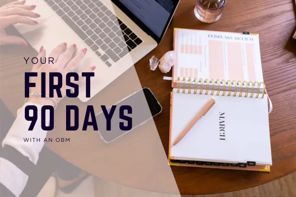 Laptop with hands typing and a planner opened at 'March'