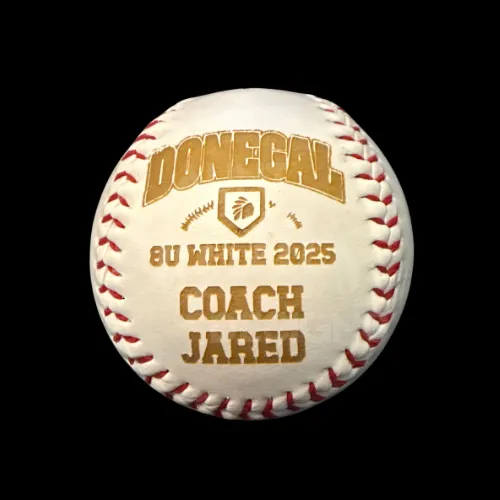 Baseball is engraved with baseball team's name and coach name.