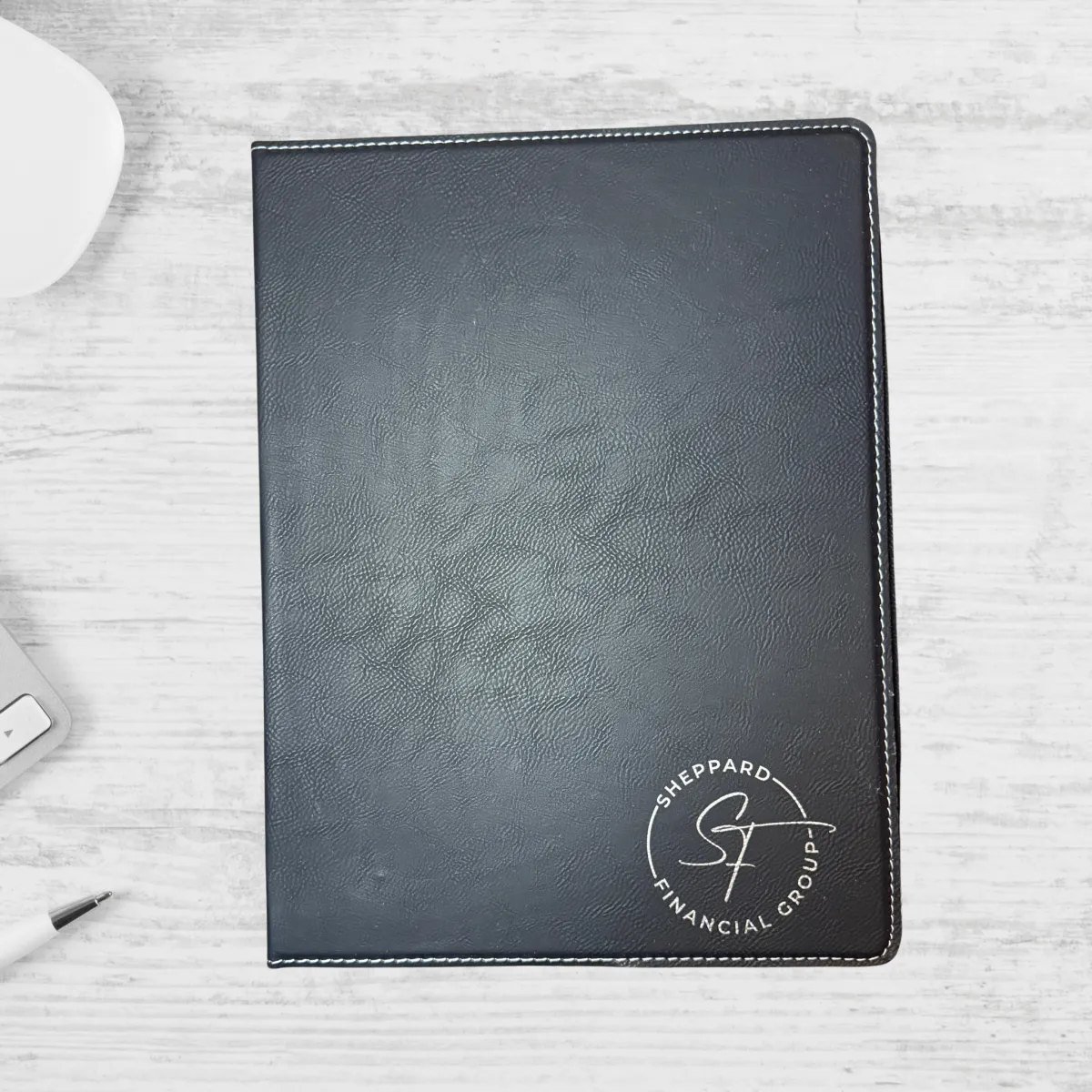 Black laser engraved padfolio with Sheppard Financial Group logo