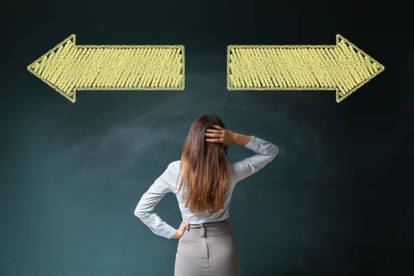 woman standing between two arrows trying to make a decision