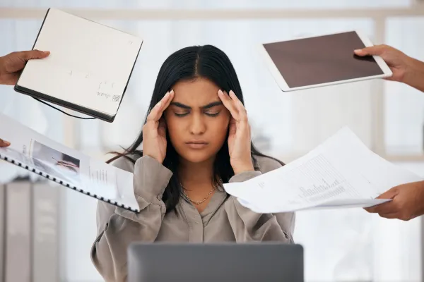 photo of women with hands to her temples feeling overwhelmed