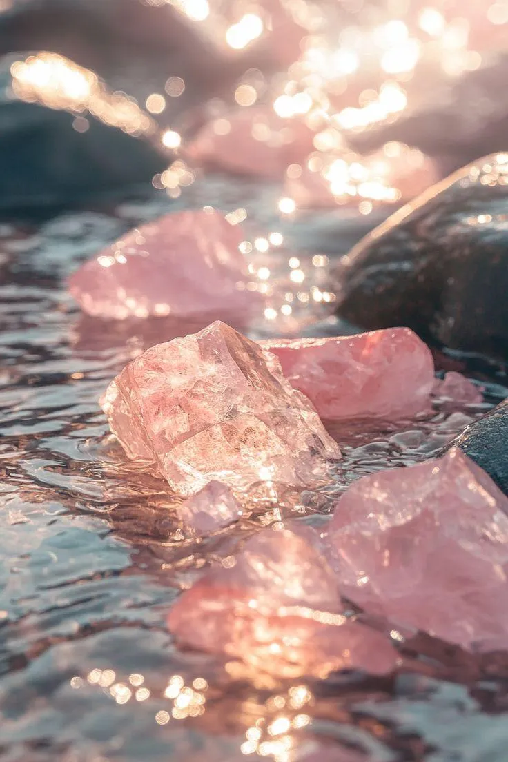 Pink healing crystal nestled in fresh spring greenery, symbolizing growth and renewal.