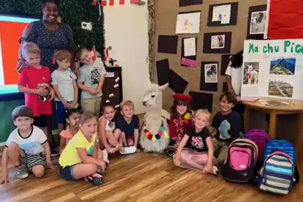children in classroom learning about Peru with alpaca