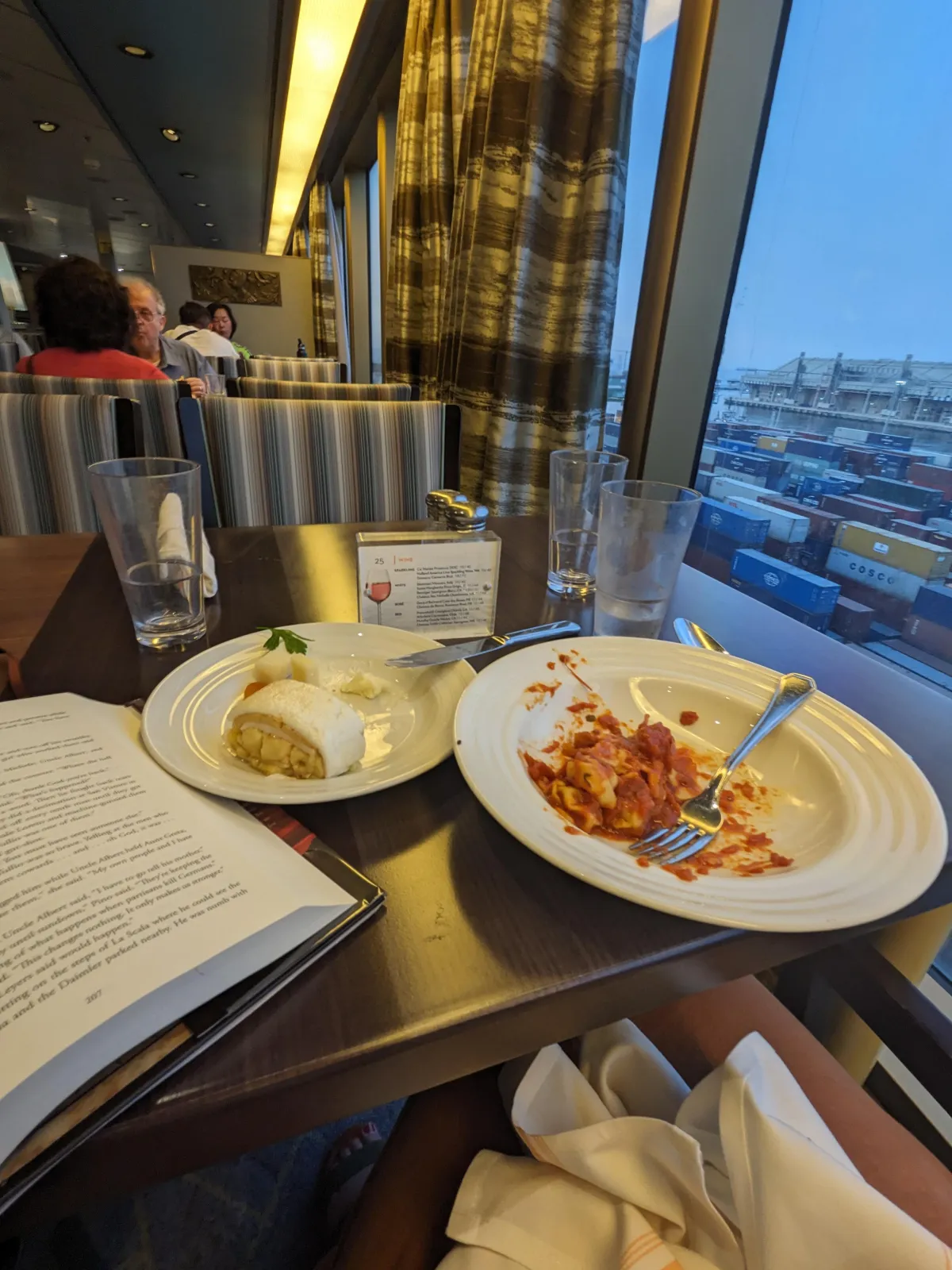 Image of me at the table eating Lasagna and Apple Roll 
