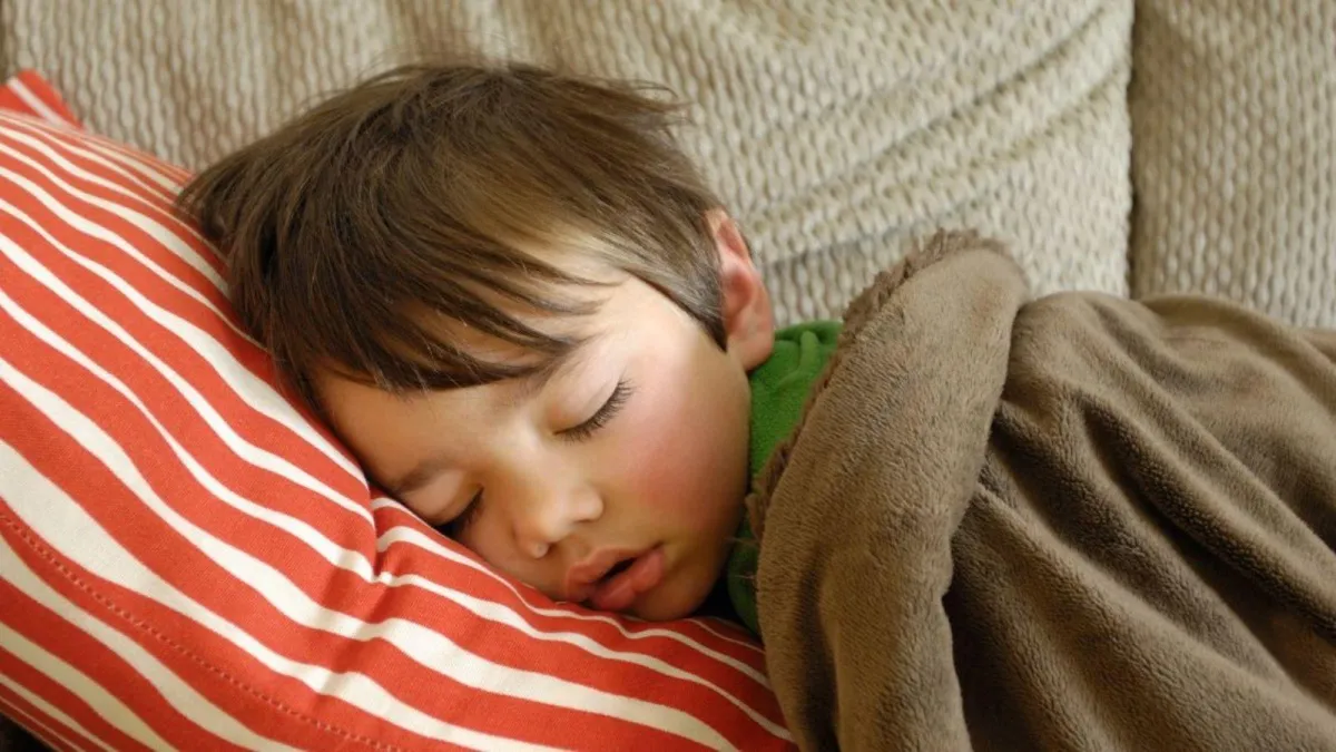 Child Napping on the Couch Showing the Importance of Sleep in Children