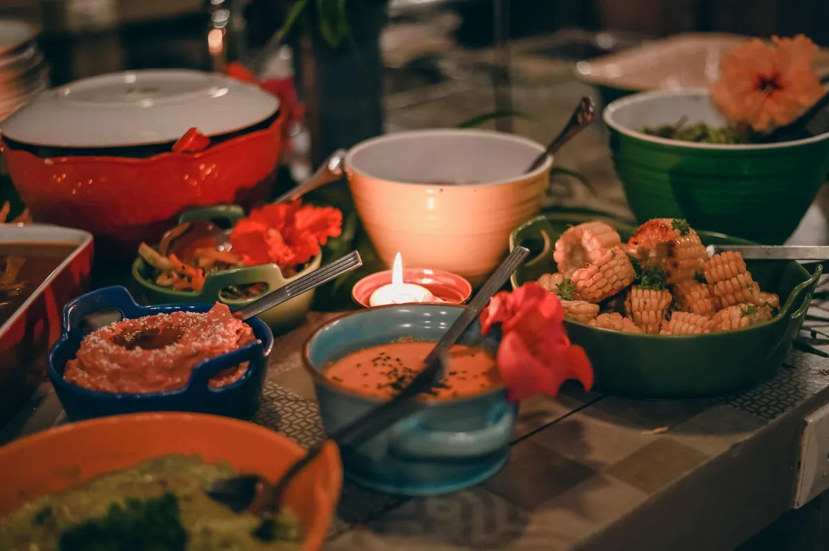 A smorgasbord of deliciousness surrounds a single candle. Food by @mestiza_foodcostarica, photo by @hestiaphotoexperience