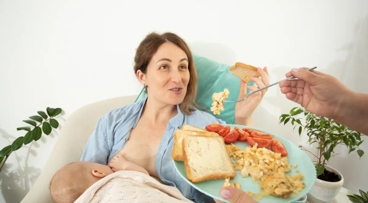Mother Breastfeeding Baby while Eating