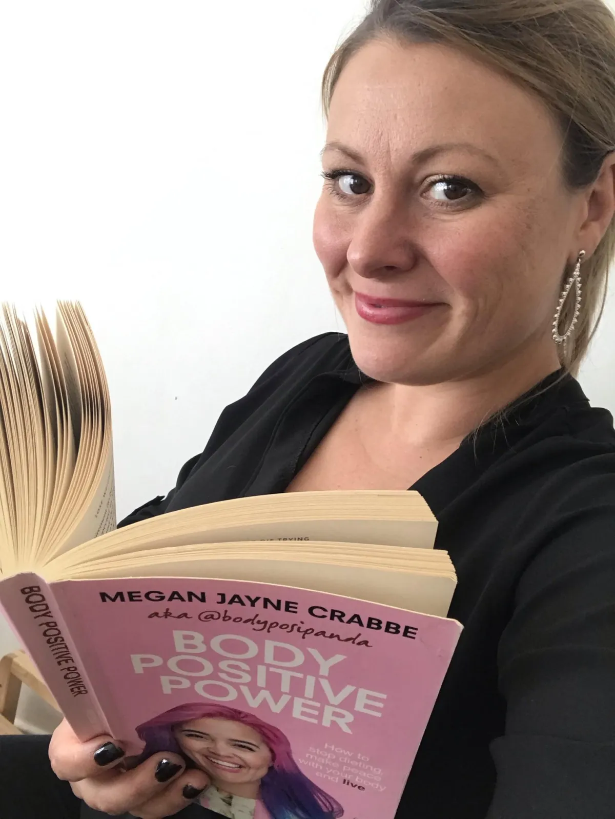 Lisa reading Body Positive Power by Megan Jayne Crabbe