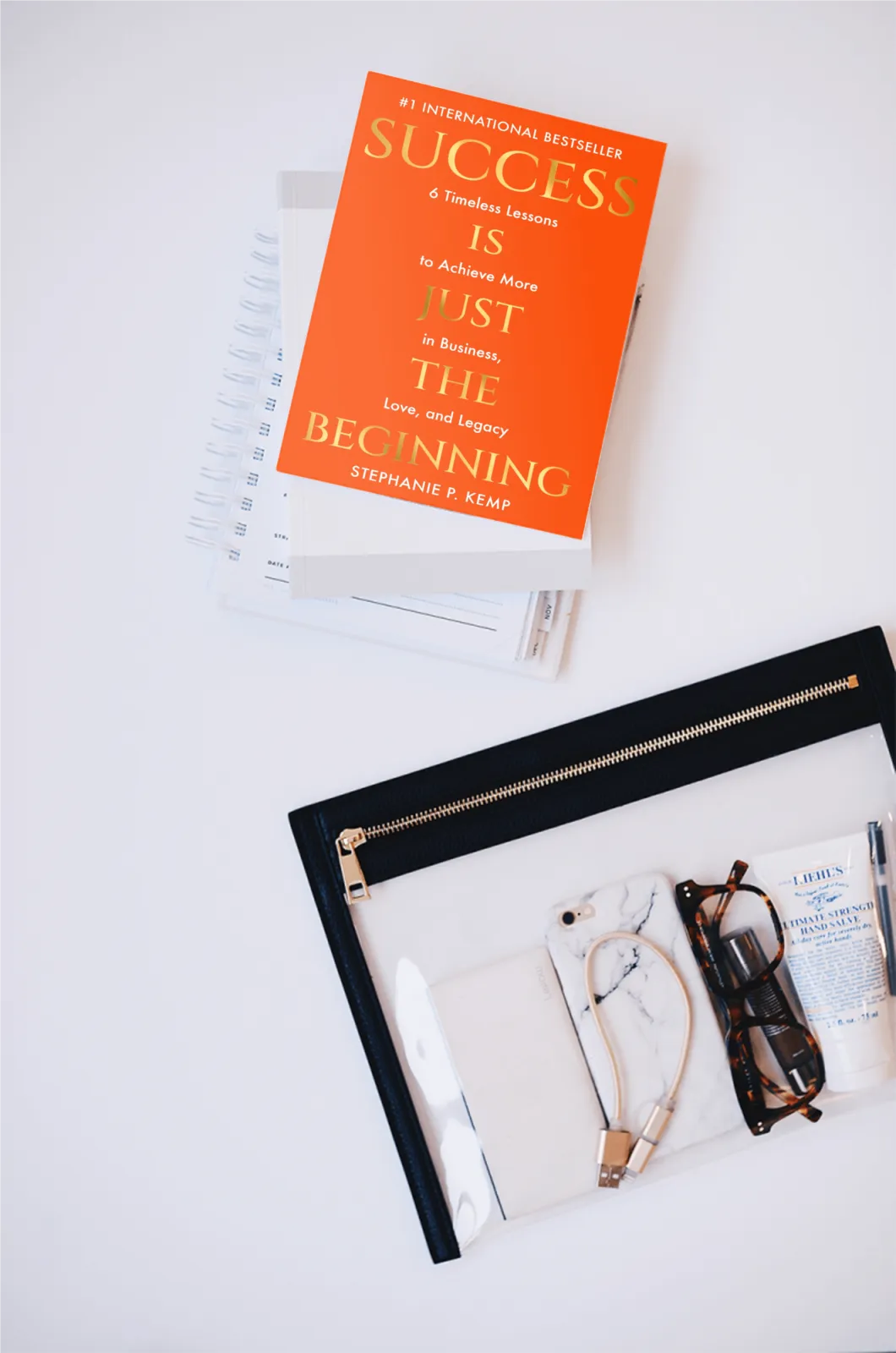 A planner next to Stephanie Kemp's book, "Success is Just the Beginning"