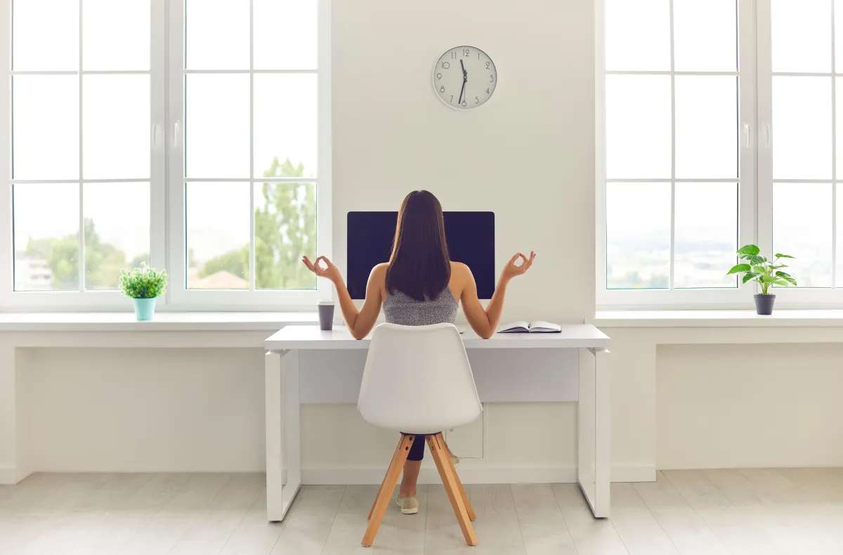 Person meditating at work station