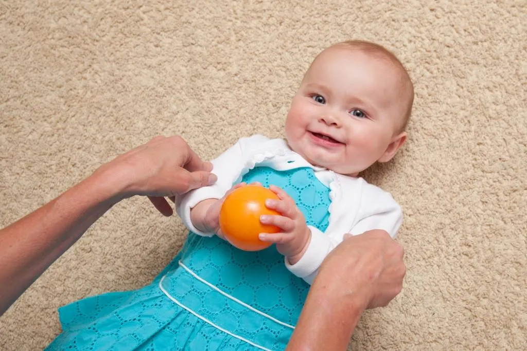 Baby on floor with ball