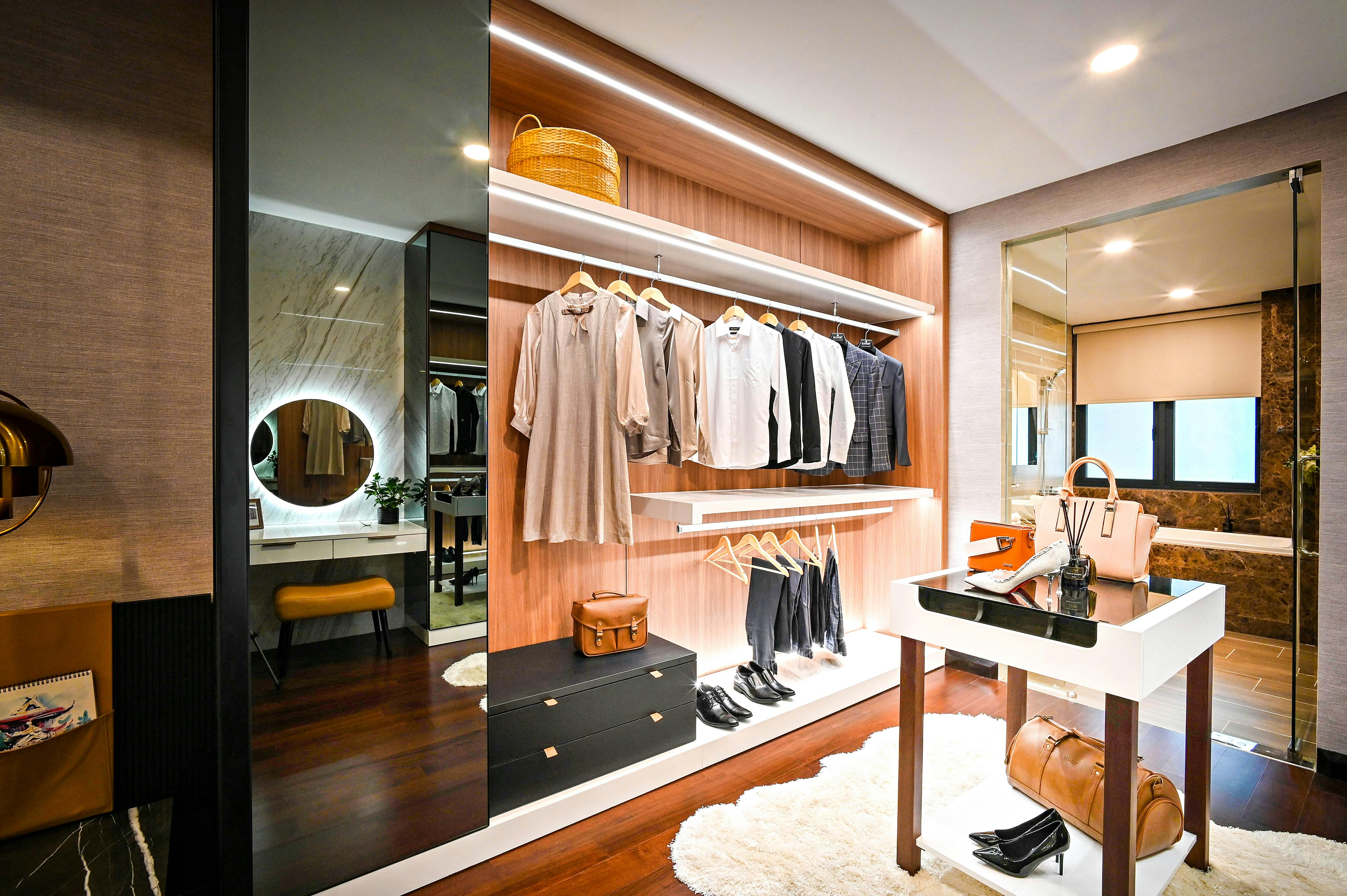 Walk in wardrobe with brown wood walls and mirror