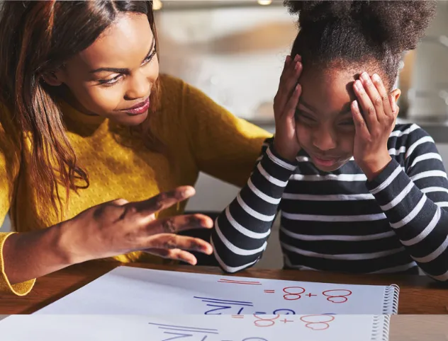 A student and her mom working on a math problem.