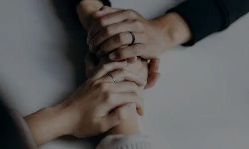 several hands holding each other