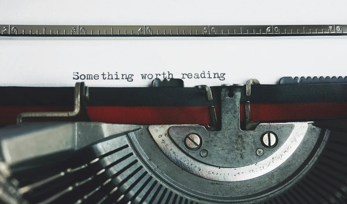 A typewriter with the words "something worth reading" on the page