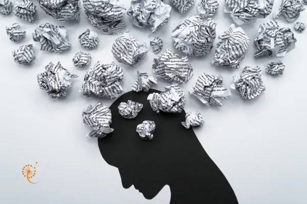silhouette of a person with crumpled paper in their head