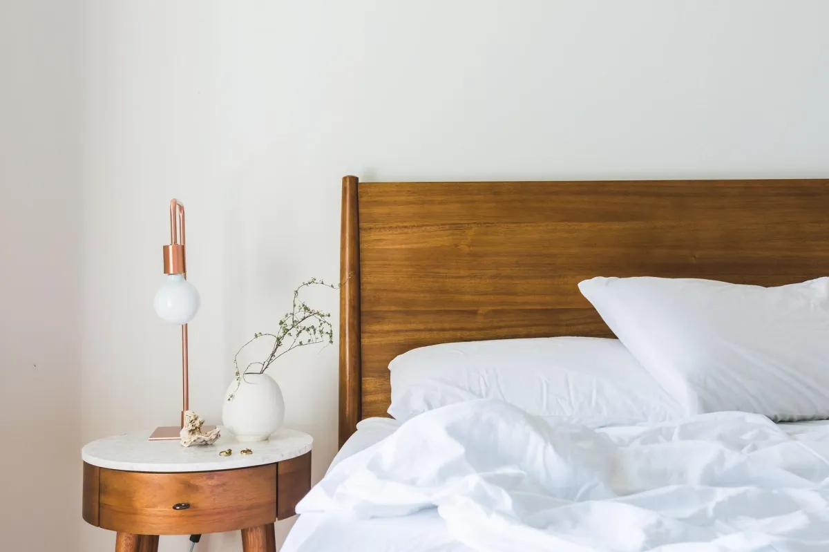 bed with wooden headboard