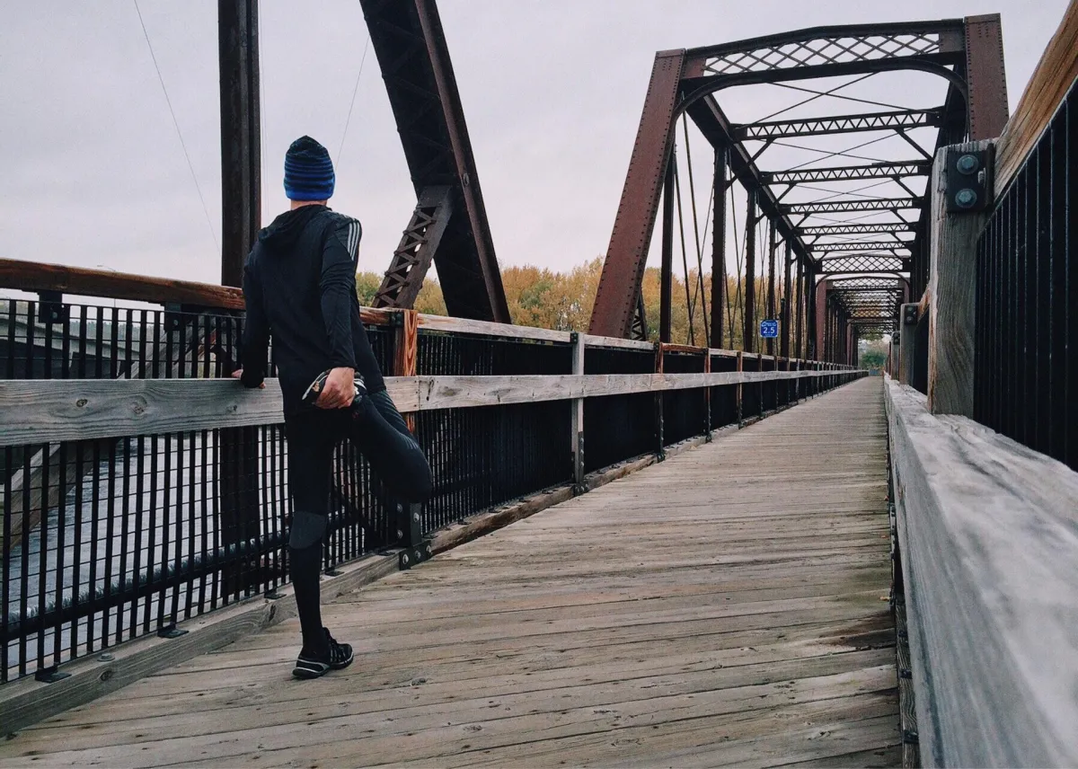 man running on a bridge