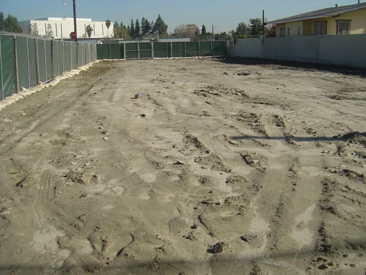 A bare dirt lot that is graded to level and ready for affordable housing to be built