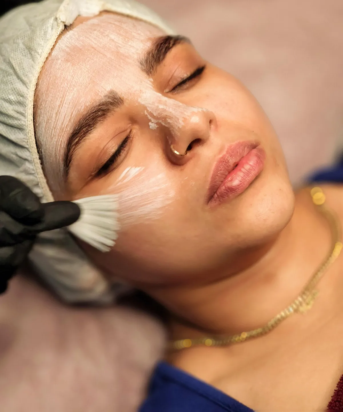 image of woman experiencing a facial at feather touch aesthetics moonah hobart