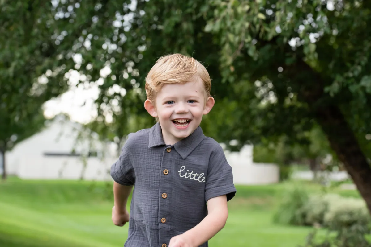 Birthday boy running with greenery