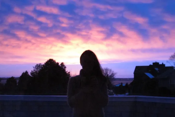 Sunrise behind silhouette of Beth Manteuffel